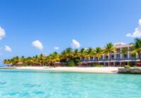 Beachfront hotel with turquoise waters and palm trees